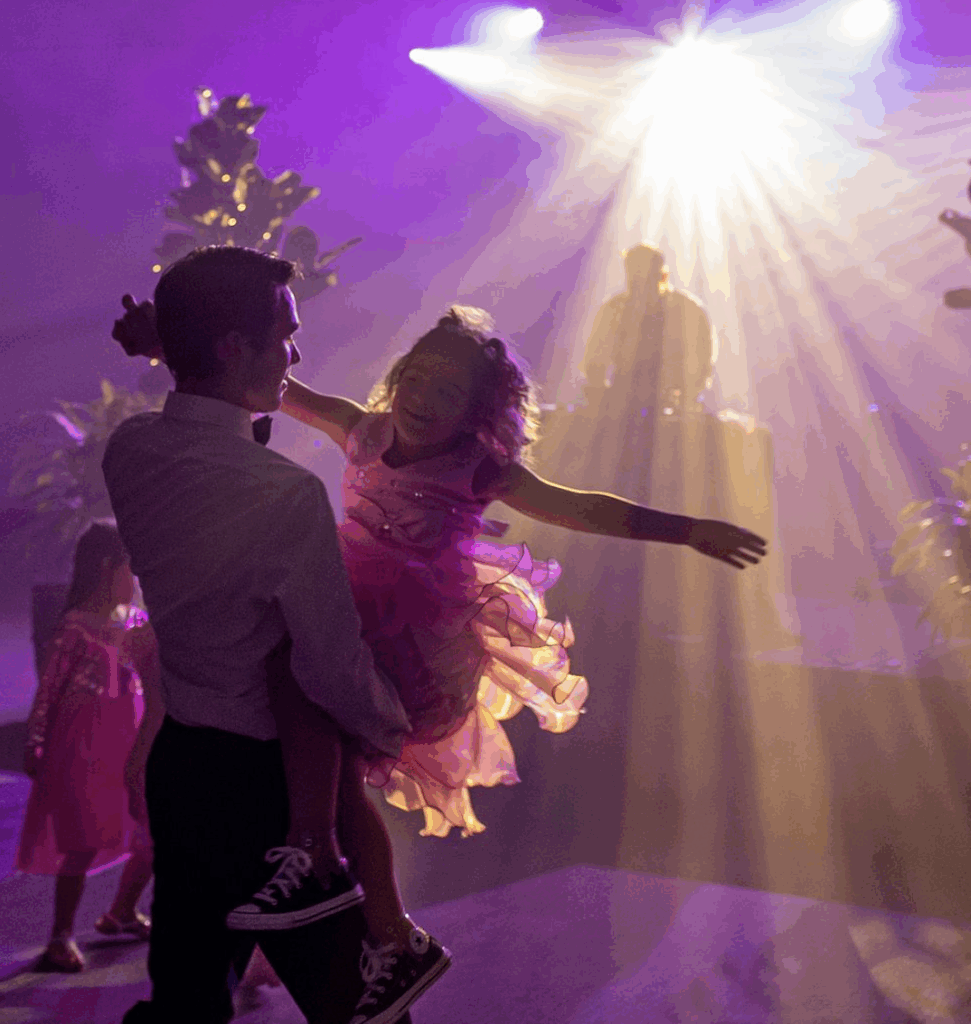 dad holding and dancing with daughter